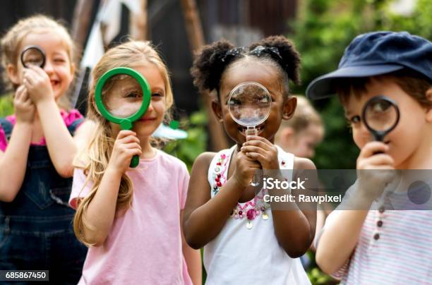 Group Of Kindergarten Kids Friends Holding Magnifying Glass For Explore Stock Photo - Download Image Now