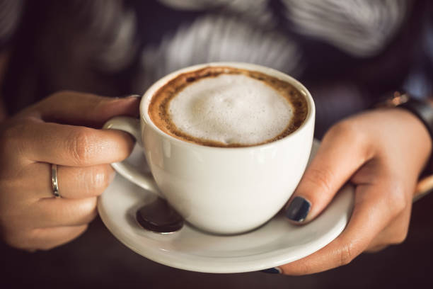 istock woman hand holding a cup of coffee 685867642