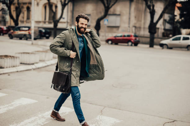 istock Handsome man walking down the street 685870534