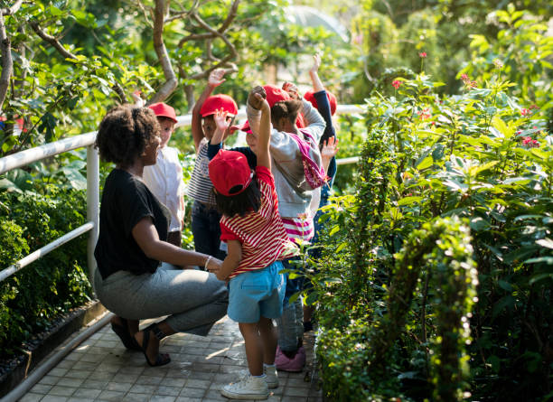 istock Teacher and kids school learning ecology gardening 685870992