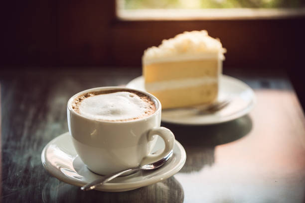 istock cup of coffee and cake on wooden table 685871308