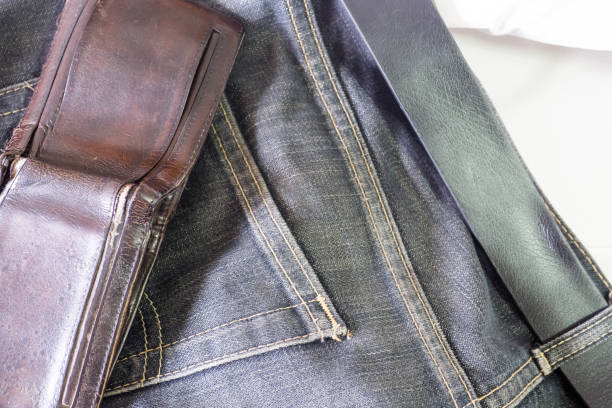 istock Empty blue old dirty jean with brown wallet on top 685871516
