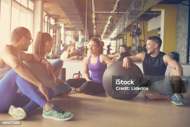 Group Of People Workout In Healthy Club People Having Conversation After Pilates Exercise With Pilates Ball Stock Photo - Download Image Now