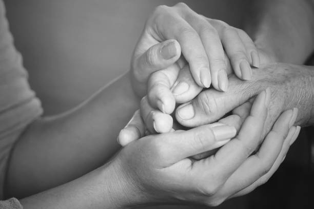 istock a daughter holding her father's hand on Father's Day 685873294