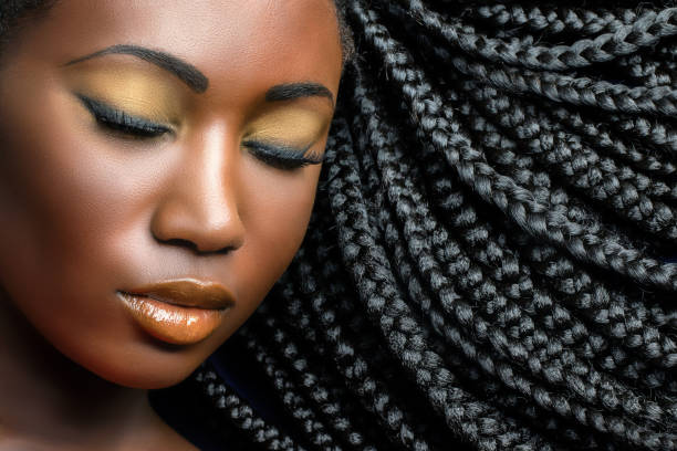 Dark girl beauty portrait with braids. Extreme close up beauty cosmetic portrait of young african woman  with eyes closed.Girl wearing professional make up showing black braided hairstyle. black woman hair braids stock pictures, royalty-free photos & images