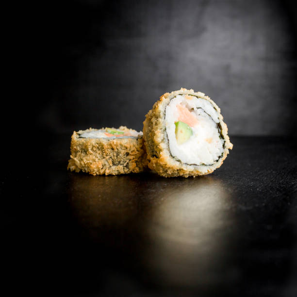 istock Sushi rolls on dark background. Japanese food. 685882344