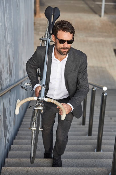 istock Businessman carrying bicycle on steps in city 685882748