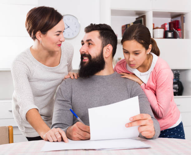 istock Parents signing property papers 685882862