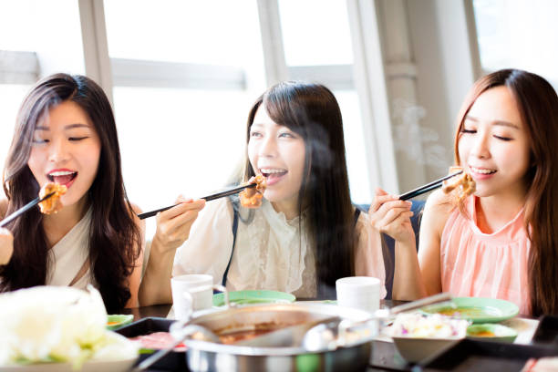 istock happy young Women group  Eating hot pot 685884096