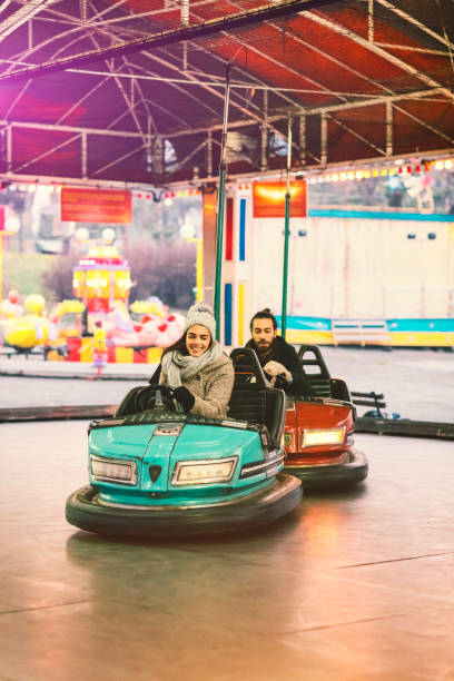 istock Couple Having Fun Riding Bumper Cars 685891146