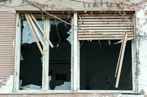 istock Broken window of burned abandoned house. 685891360