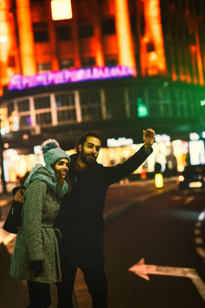 istock Young Couple Calling Late Night Taxi 685892712