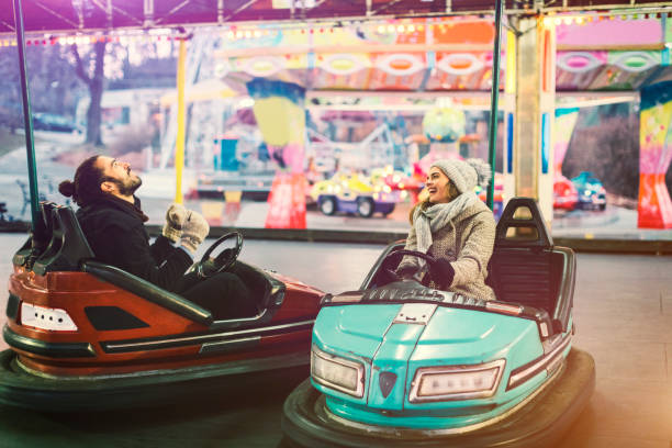 istock Couple Having Fun Riding Bumper Cars 685893126