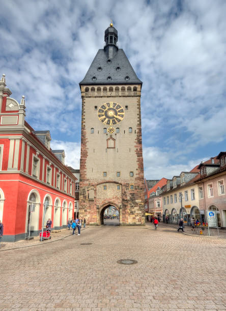 Tourists walk in the mainstreet in front of the old clock tower in the old centre of Speyer, Germany on May 2, 2014