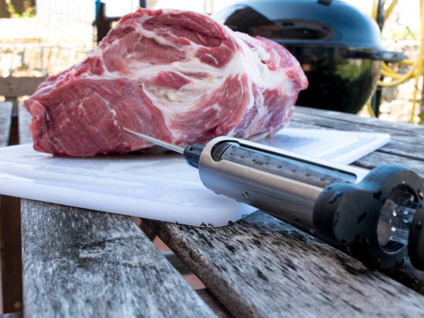 istock Pork cutlet injecting with food syringe 685896830