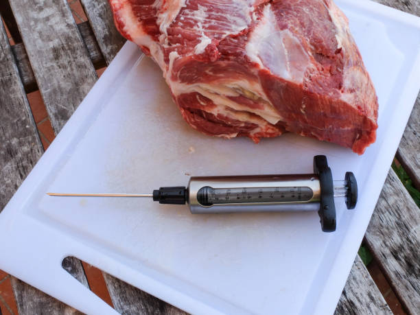 istock Pork cutlet injecting with food syringe 685896908