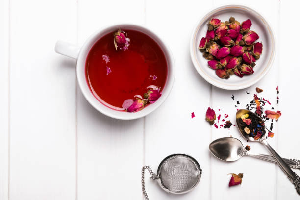 istock Herbal tea with roses on white wooden table 685897620