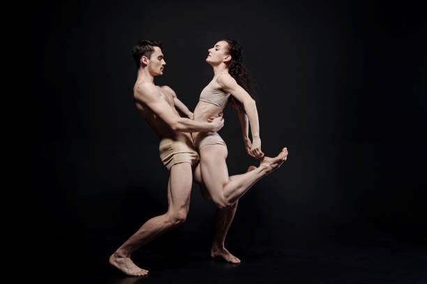 istock Undistracted dancers performing in the black colored studio 685907606