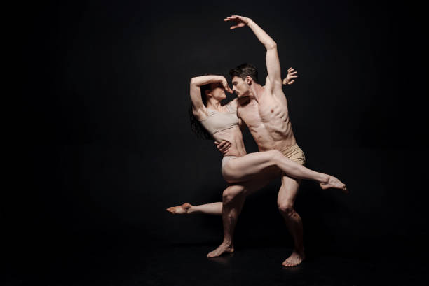 istock Slim young performers acting in the black colored studio 685910712