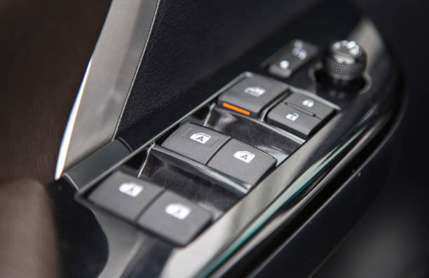 istock Car interior details of door handle panel with windows controls and adjustments 685912172