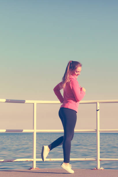 istock Woman doing sports exercises outdoors by seaside 685920506