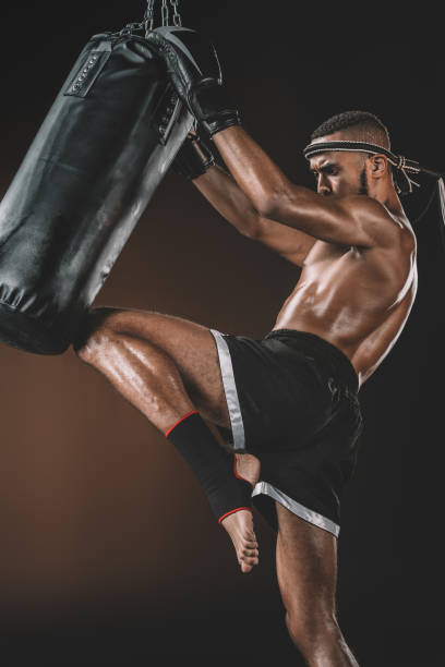 istock side view of muay thai fighter training with punching bag, action sport concept 685924568