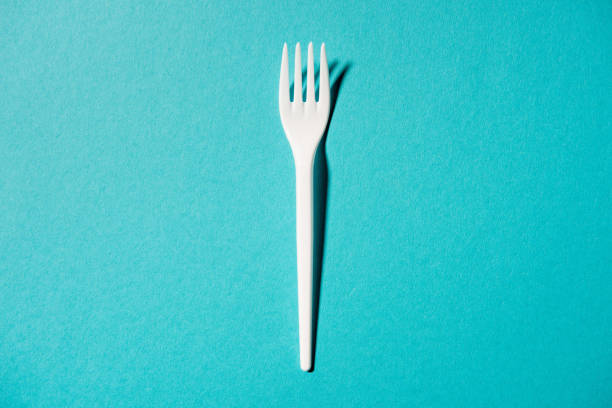 istock top view of white plastic fork isolated on blue 685927378