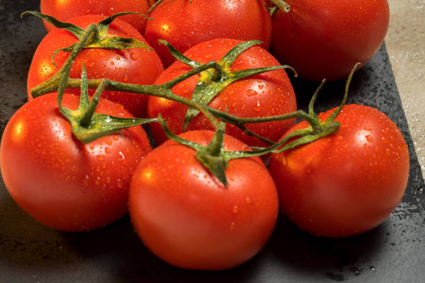 istock bunch of red ripe wet tomatoes 685945906