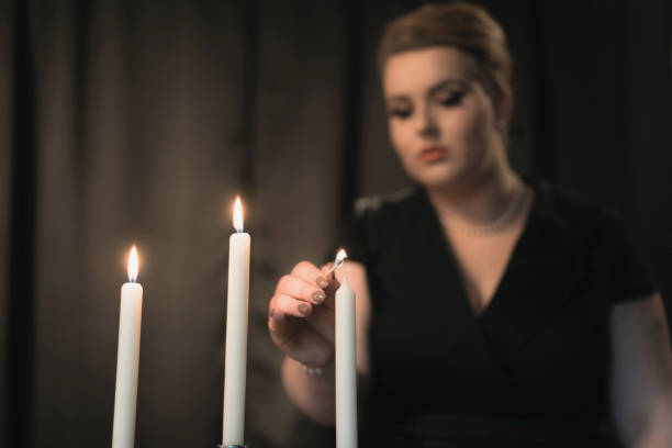 istock Retro 1950s style woman lighting candles for supper. 685951698