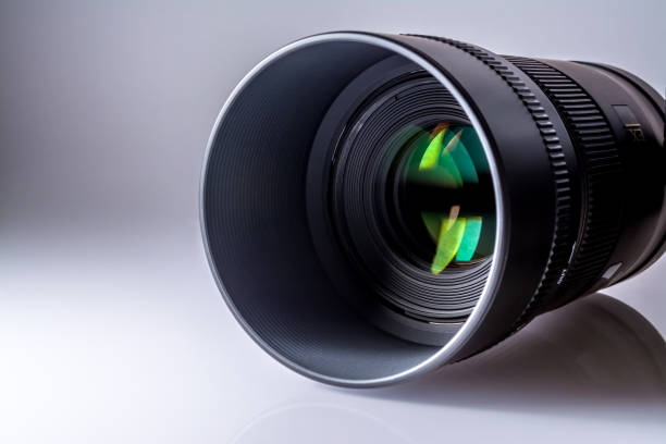 istock Lens of a SLR camera close-up with a reflection on a grey-white background 685964102
