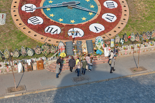 Kiev, Ukraine - October 16, 2015: Unrecognized people visit memorial to the Hundred of Heaven Heroes, victims of anti-president and anti-government protests EuroMaidan on Institutska street.