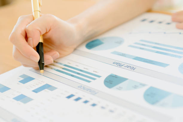 istock Businesswoman Analyzing Financial Graph With Coins 685968128