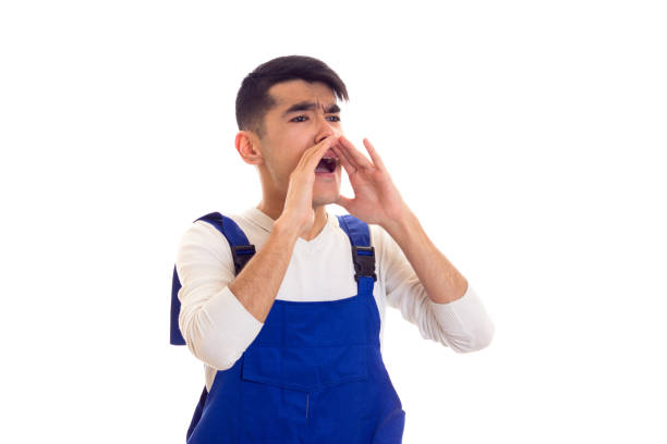 istock Young man in blue overall shouting 685977560
