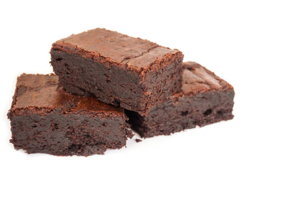 istock Sliced homemade brownies tower on white isolate background. 685996742