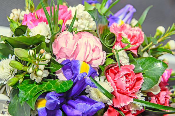 istock Floral arrangement with colored flowers roses, iris, chrysanthemums, Carnations, green leafs 685996920