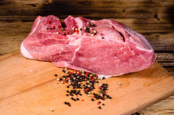 istock Raw pork meat and different spiceson cutting board 686027066