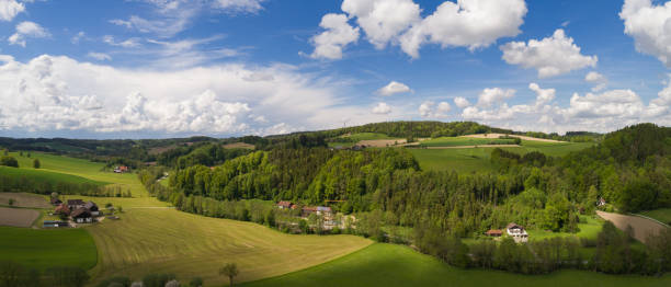 Aereal image of a bavarian landscape Aereal image of a bavarian landscape with bright blue sky and green fields and forest. bavarian forest stock pictures, royalty-free photos & images