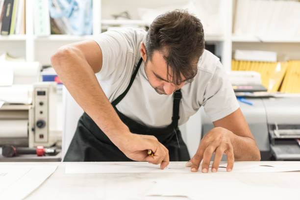 istock Mature man working at his printing-graphic design shop 686037568