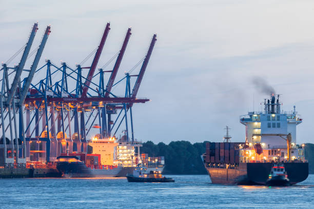 cargo terminal, large container ship assisted by tugboats in hamburg harbor, germany - hamburg germany harbor cargo container commercial dock imagens e fotografias de stock