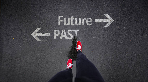 istock Red shoes standing next to past and future painted on ground 686051128