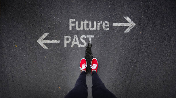 istock Red shoes standing next to past and future painted on ground 686051152