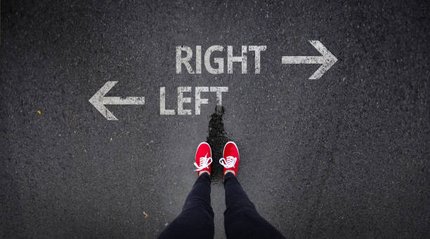 istock Red shoes standing next to right and left with arrows painted 686051170