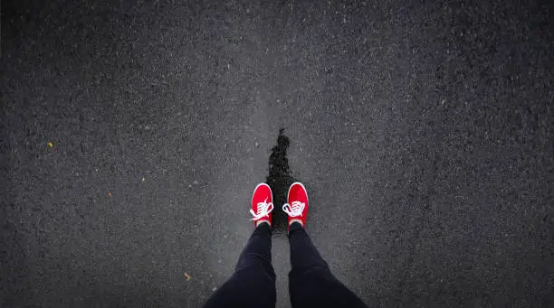 Red shoes walking in rain
