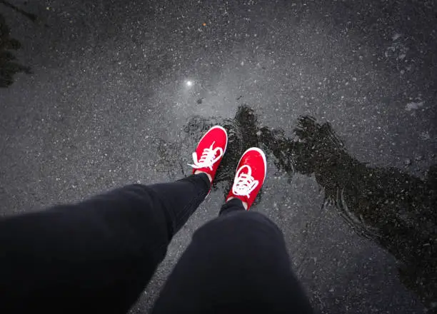 Red shoes walking in rain