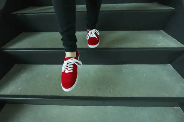 Red shoes going down stairs
