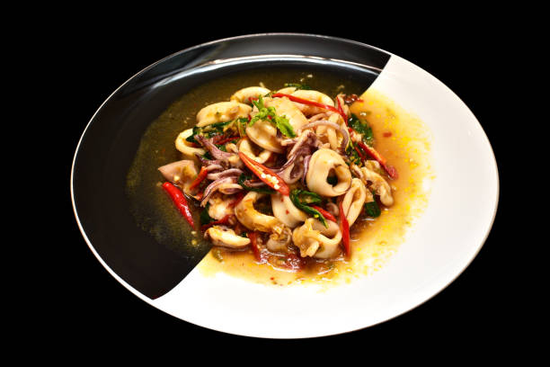 istock Fried basil squid serve on black and white dish 686051526