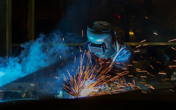 trabalhador com máscara protetora automotiva parte na fábrica de solda - human joint flash - fotografias e filmes do acervo