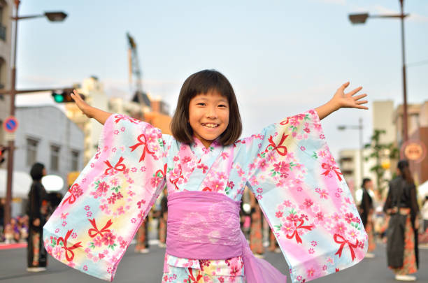 Girl in yukata enjoying summer festival Girl in yukata enjoying summer festival yukata photos stock pictures, royalty-free photos & images