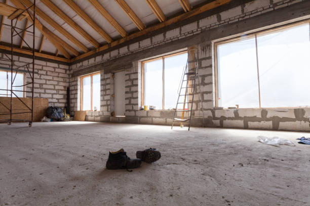 istock Interior of apartment  during under renovation, remodeling and construction (a pair of working shoes on the cement floor) 686065970