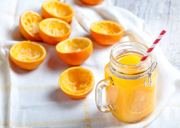 istock Orange juice isolated on white background with squeezed shells 686075128